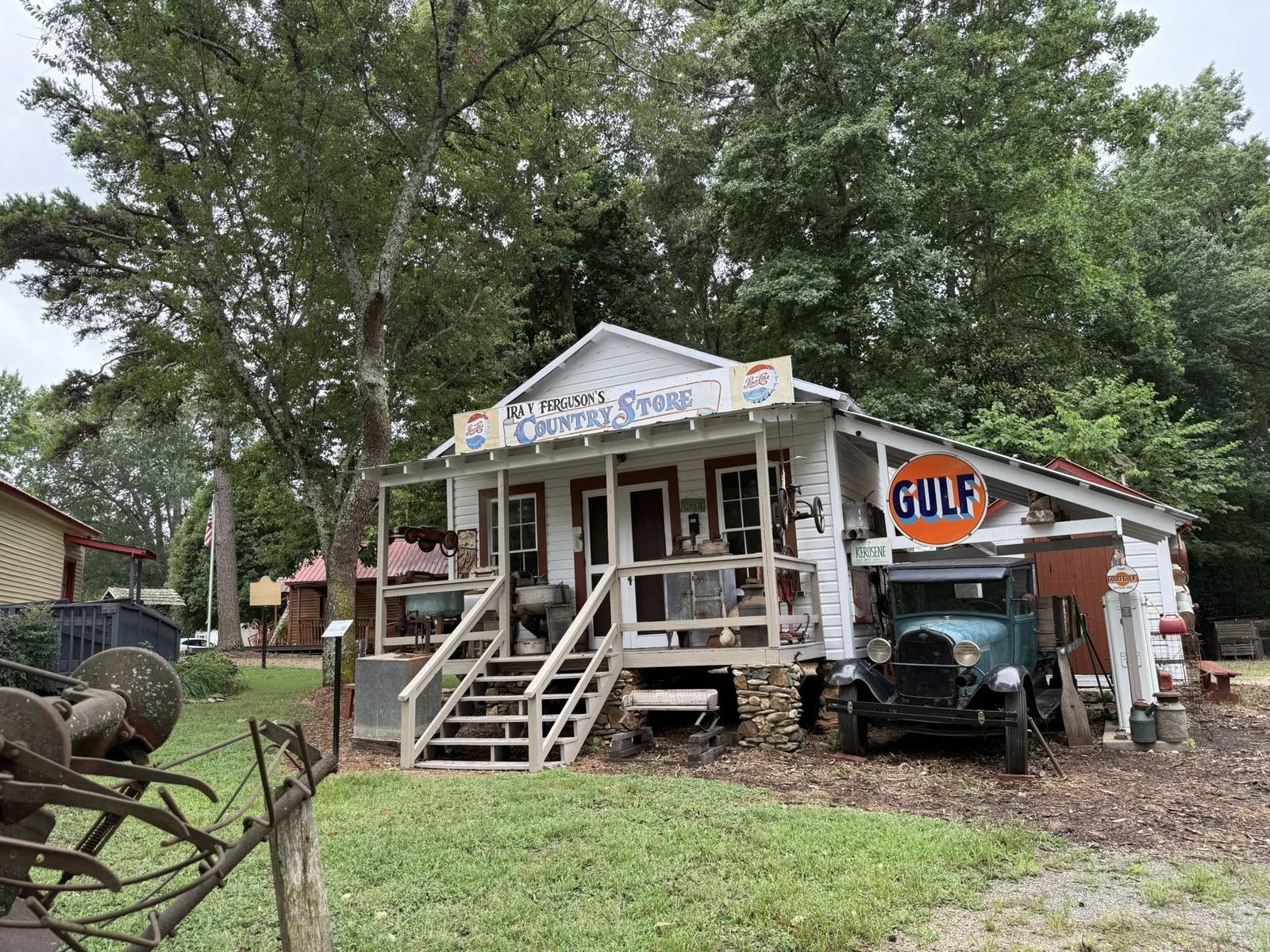 Historic general store building with a vintage Gulf sign and an old truck out front