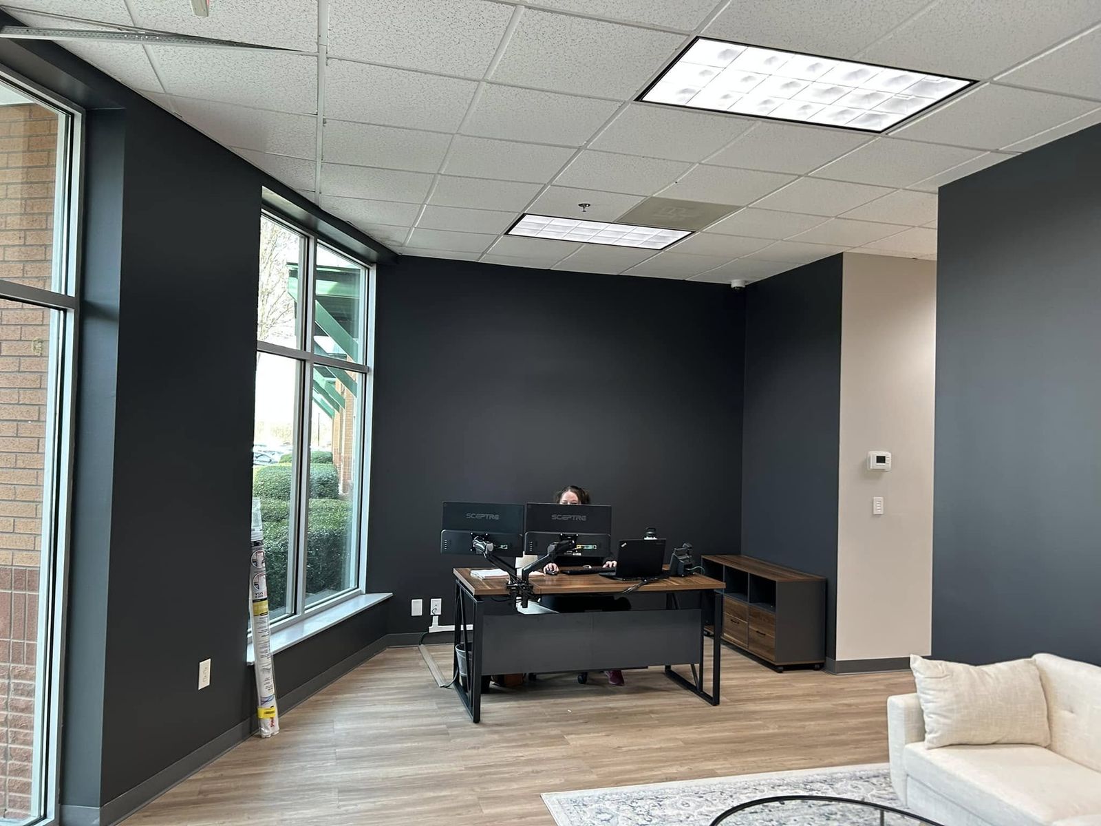 Office with a dark navy accent wall behind the desk