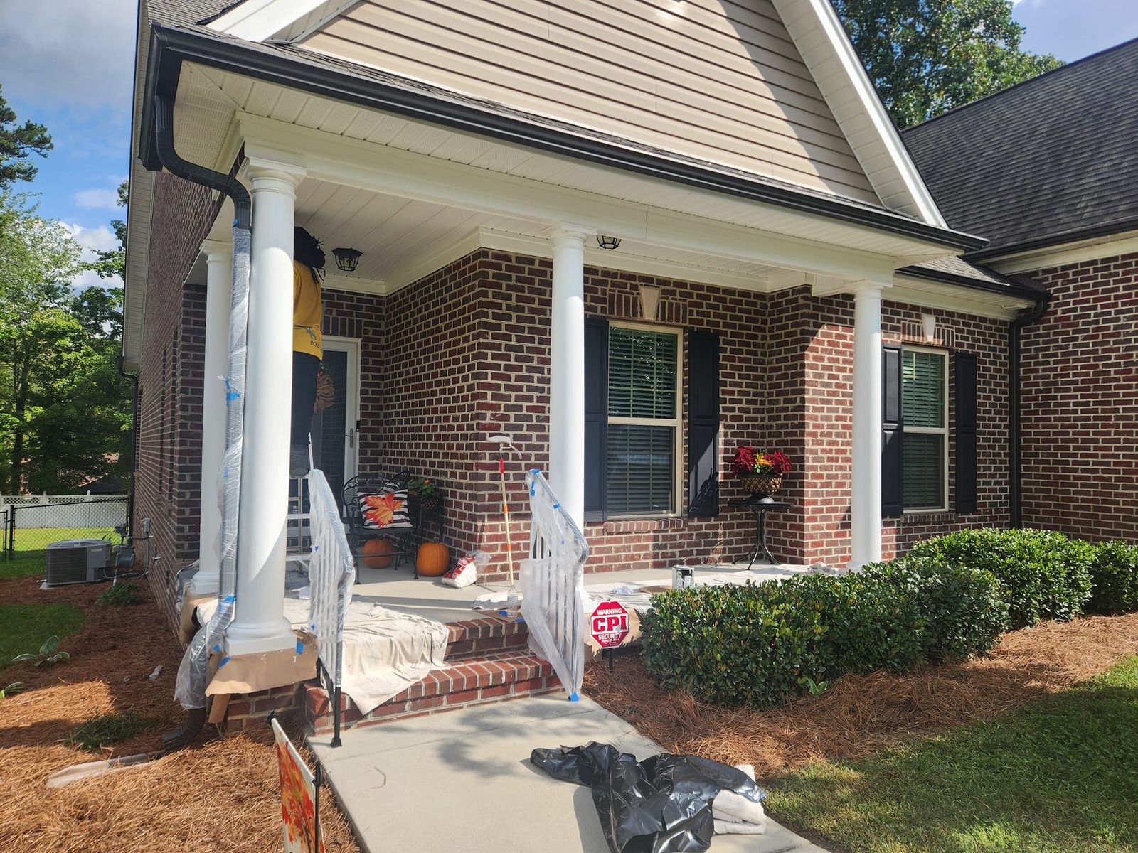 Brick home with a covered front porch and white painted columns